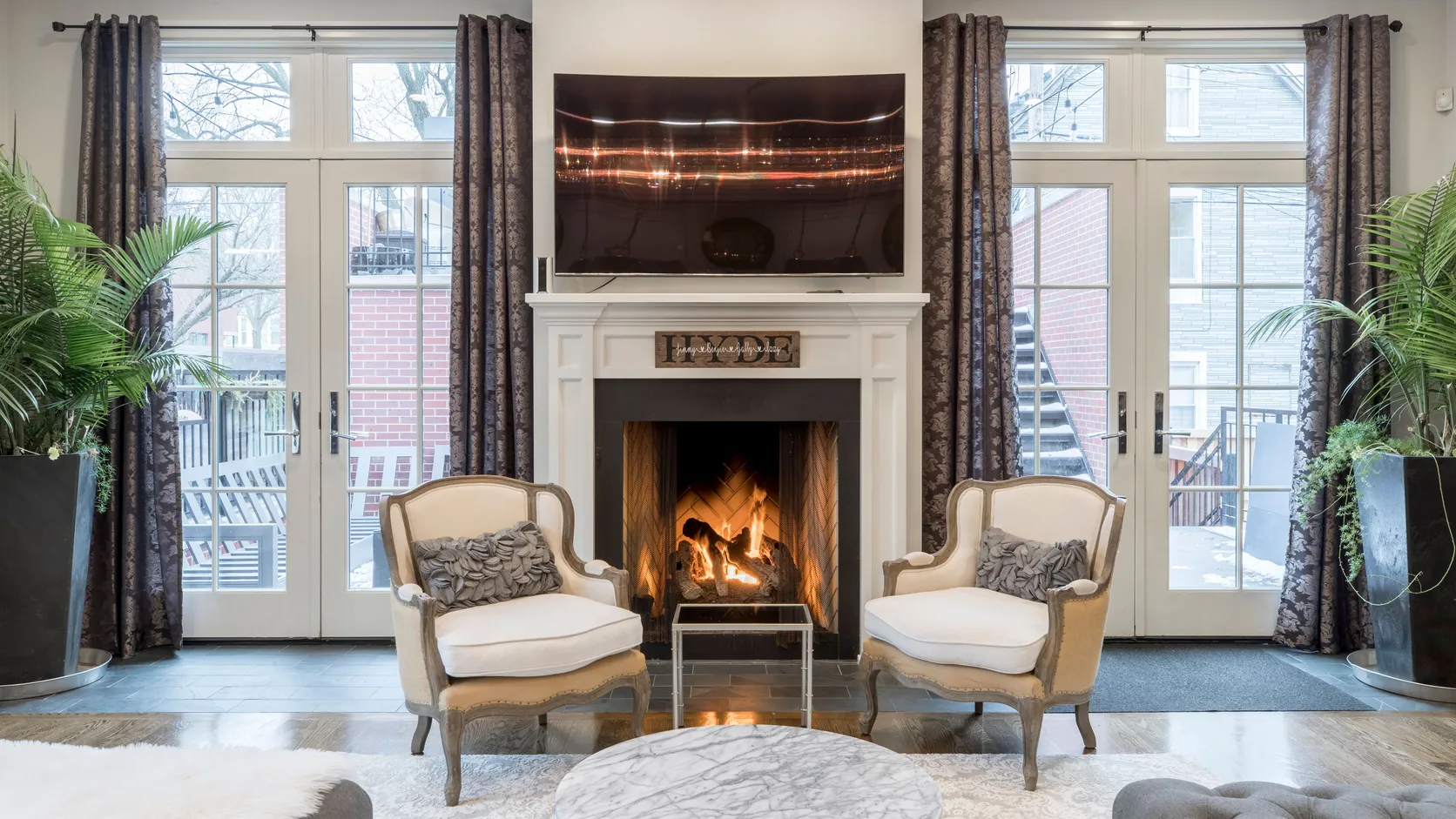 Elegant French doors flanking a fireplace in a formal living room